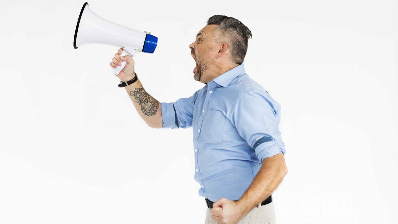 Podcaster Evo Terra shouting into a microphone, in front of a white background.