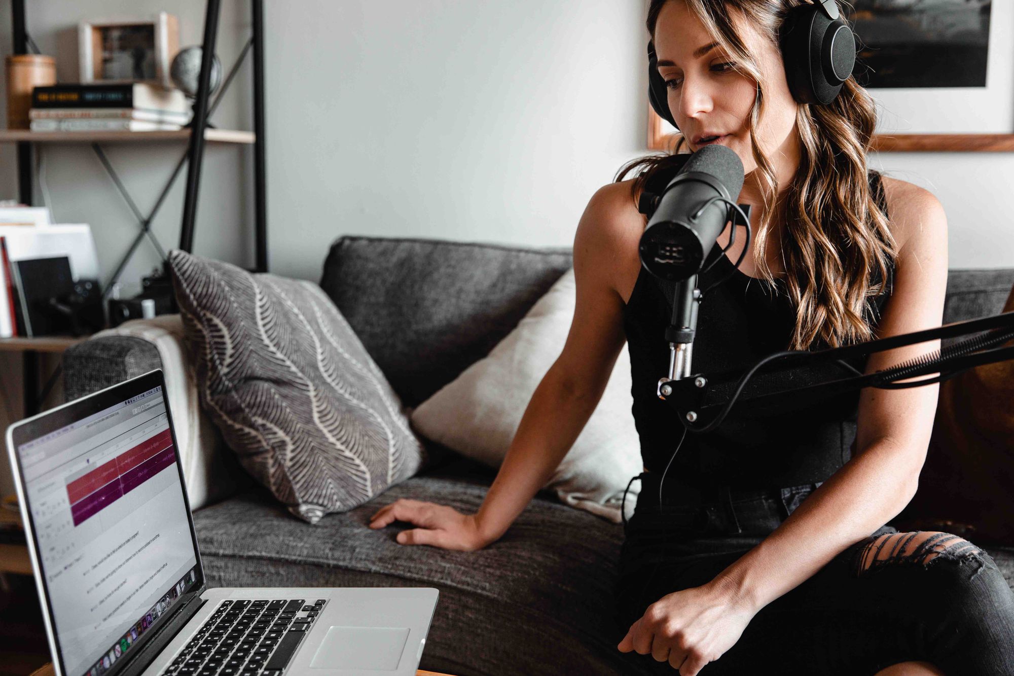 A woman recording a podcast episode.