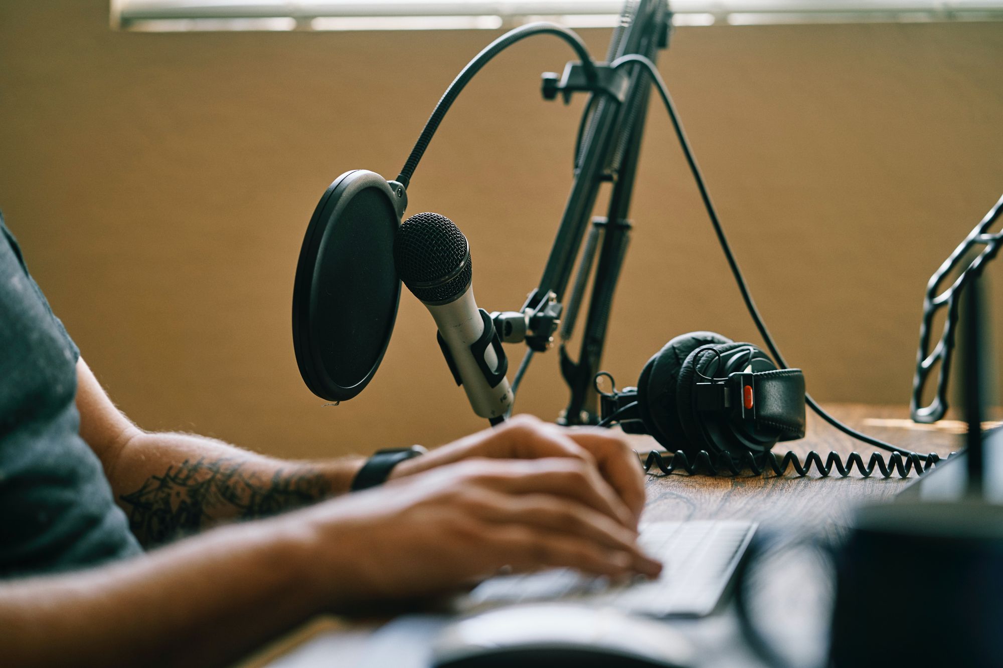 A microphone positioned at a desk.