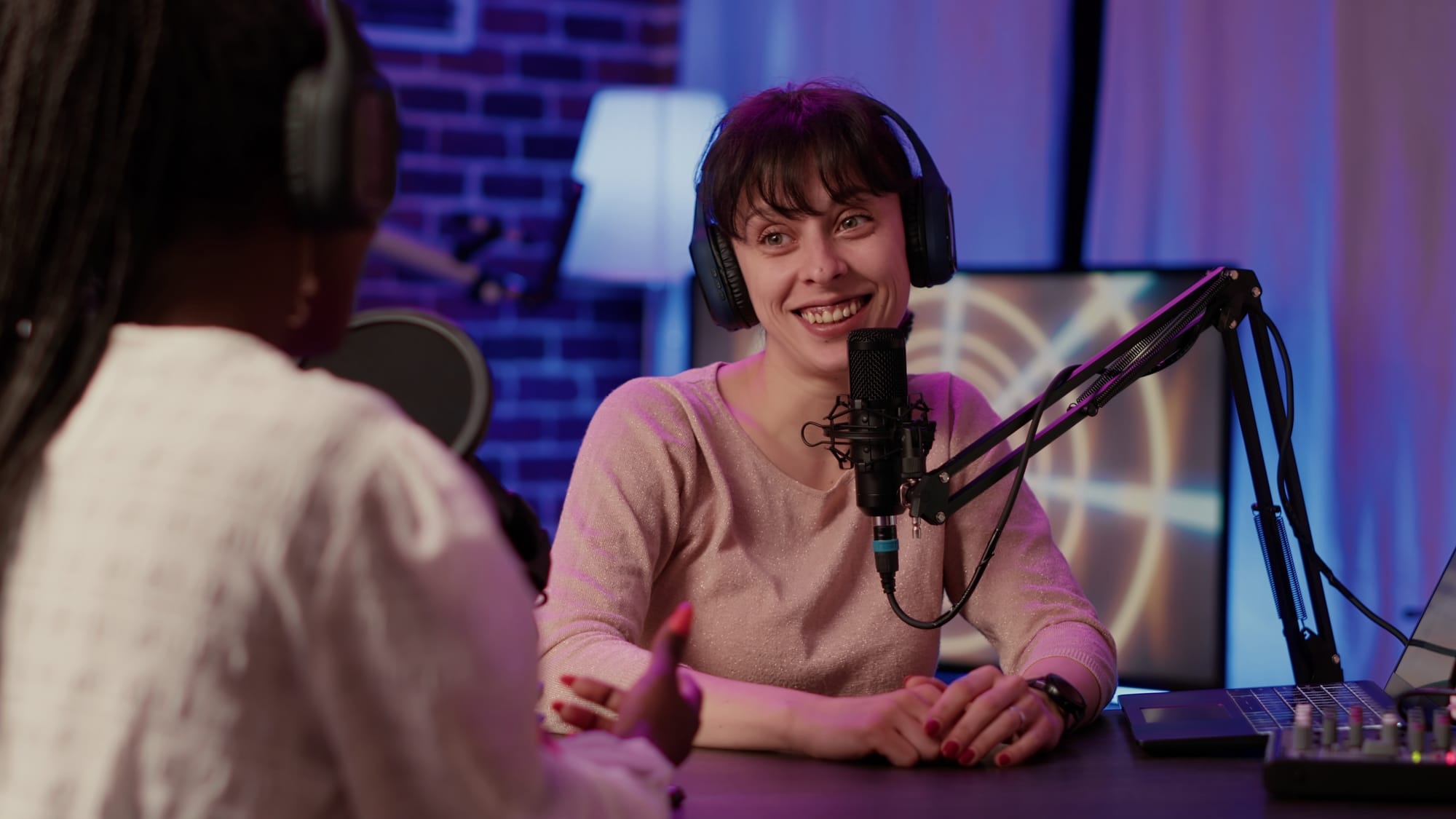 A woman being interviewed for a podcast.