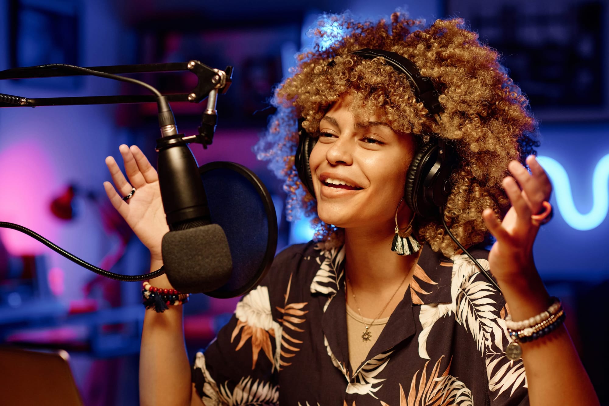 Smiling Woman In Headphones Communicating With Online Audience